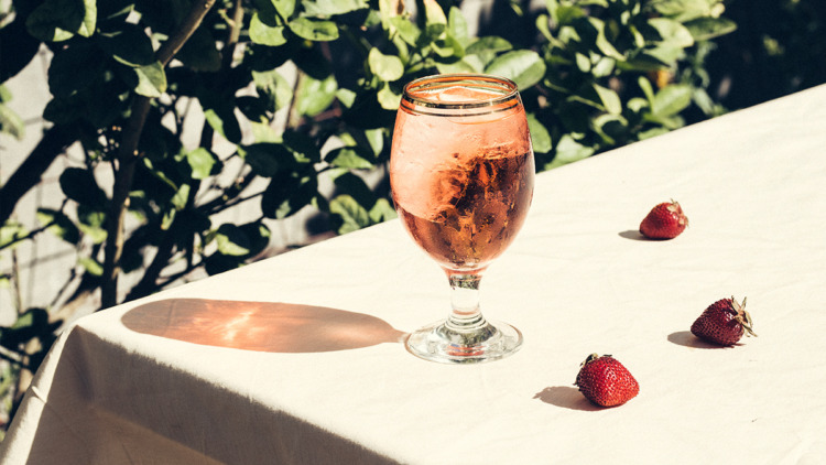 A cocktail with strawberries