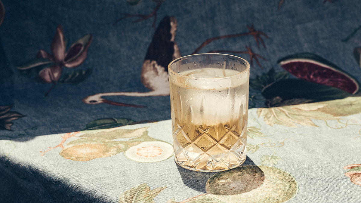 A cocktail placed on a patterned table cloth