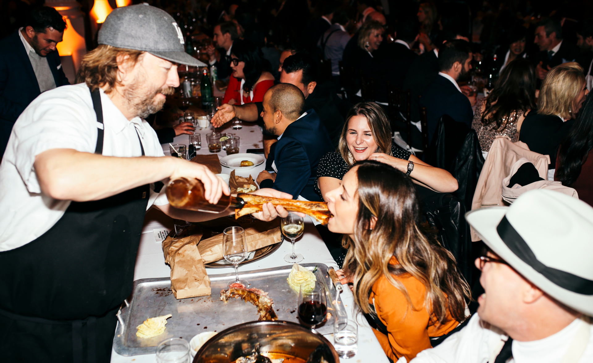 bartender pouring shot into bone marrow going into guest's mouth