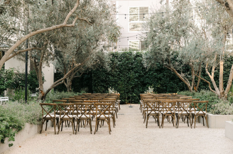 outdoor garden area setup with wood chairs for a wedding