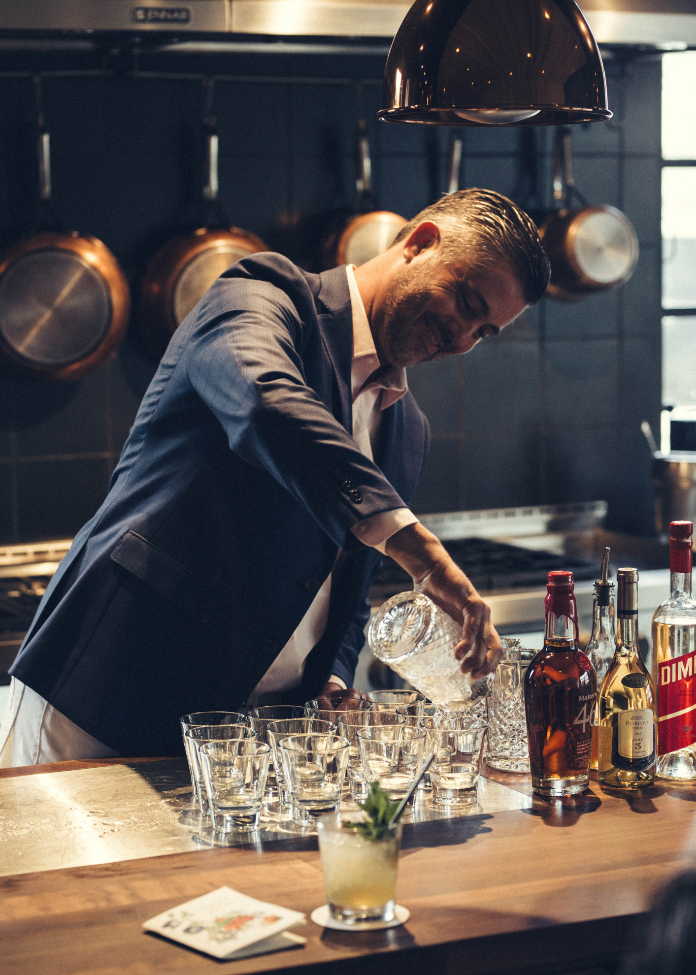 bartender making rows of drinks