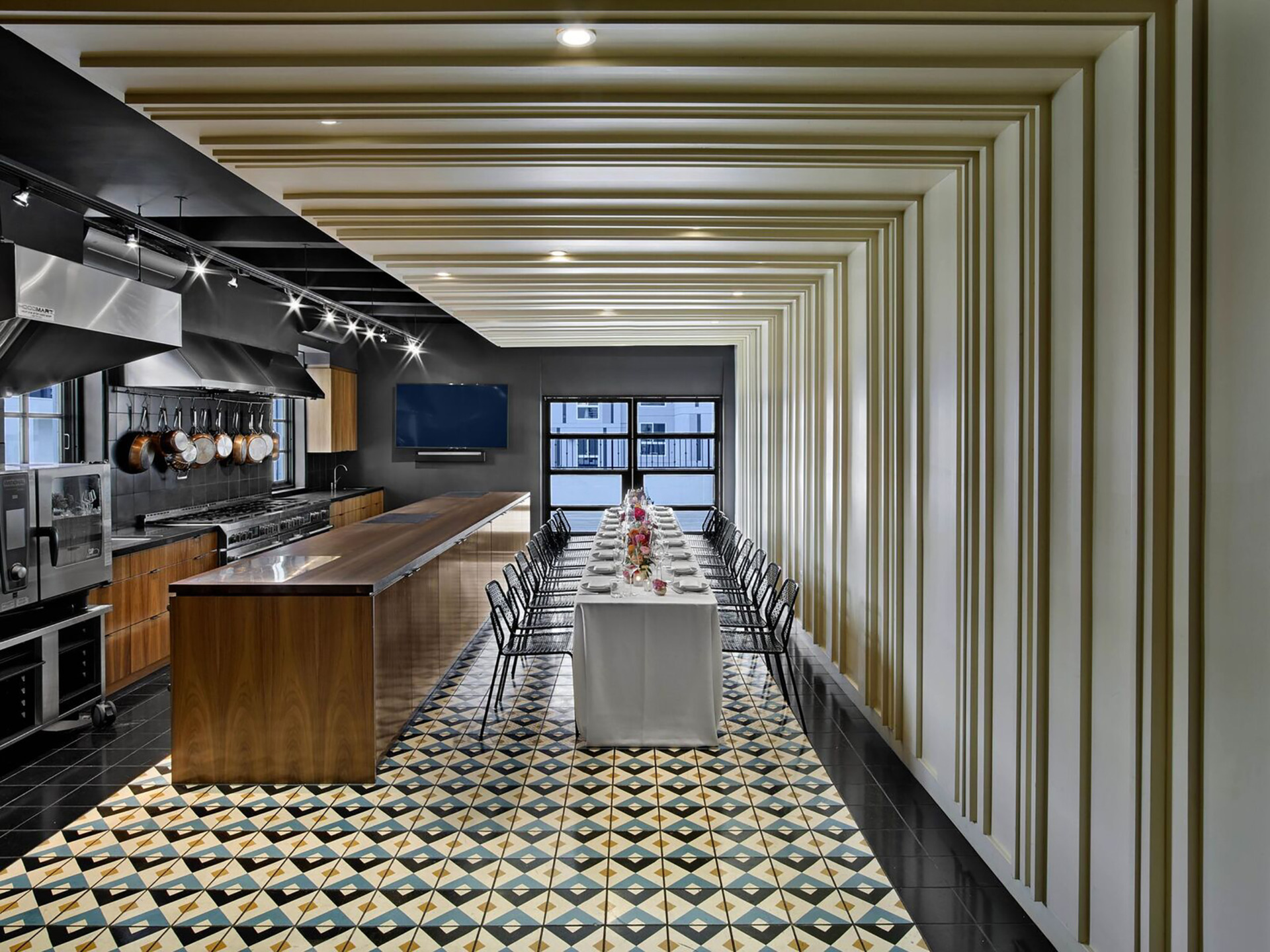 tiled dining room with long table and kitchen bar