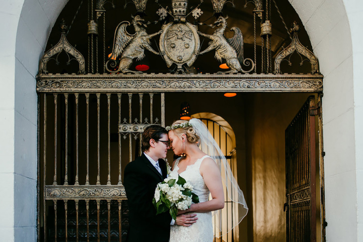 brides hugging in front of gold elaborately designed door