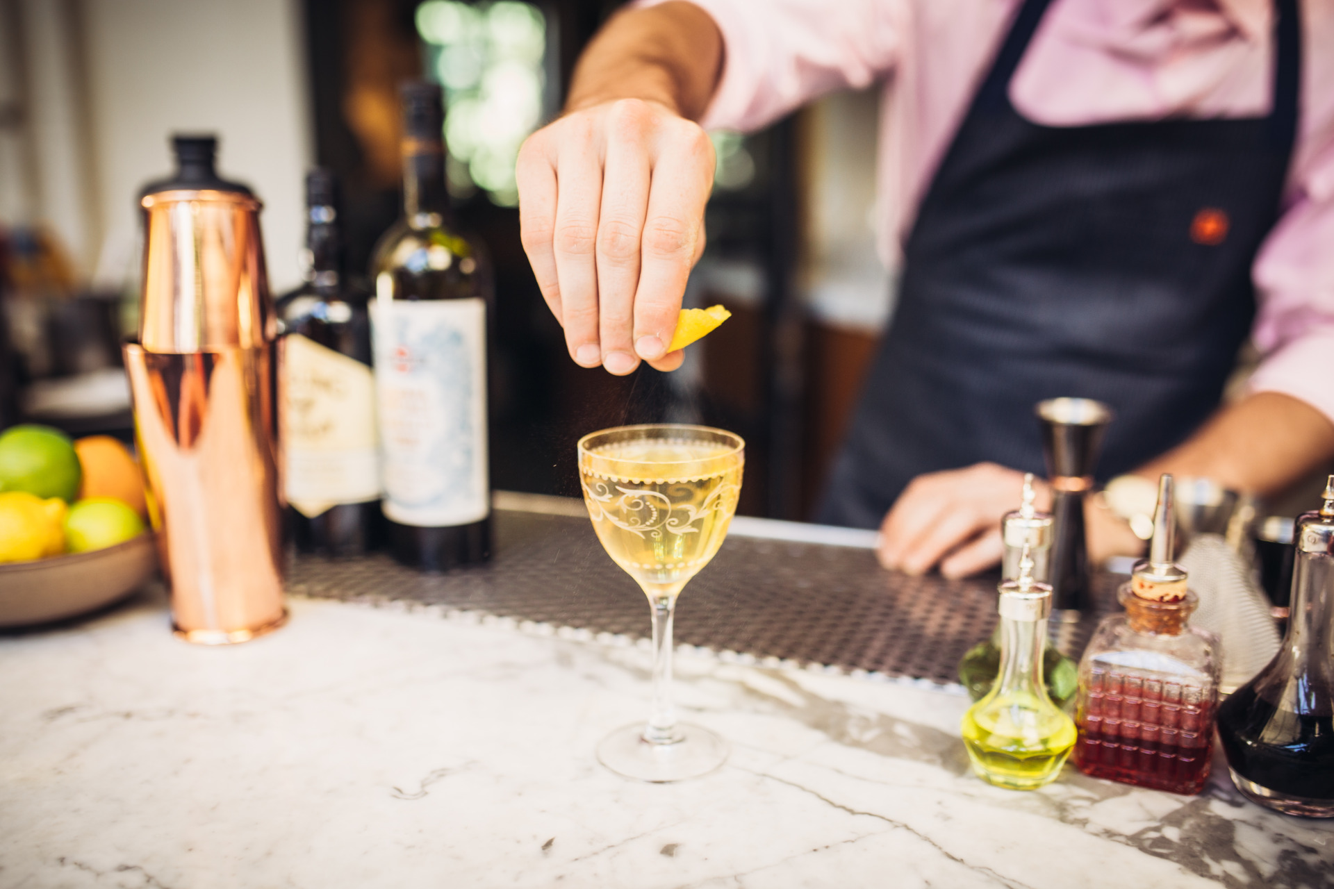 Bartender Squeezing Lemon on a Cocktail