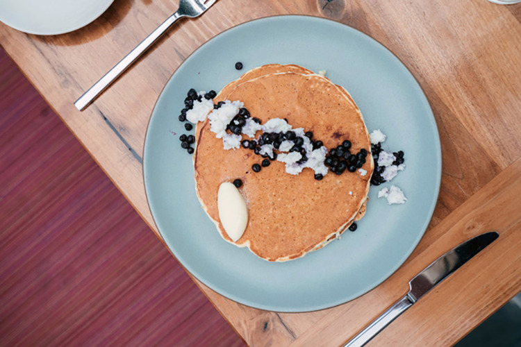 pancakes with blueberries on blue dish