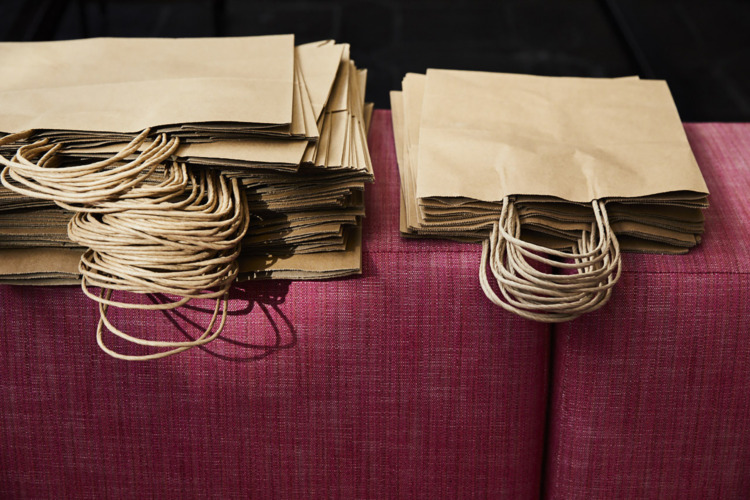 delivery bags on a pink chair