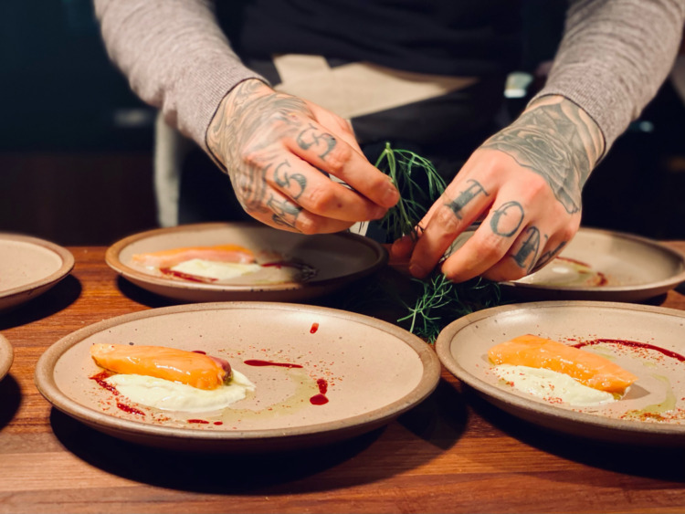 Chef hands plating salmon