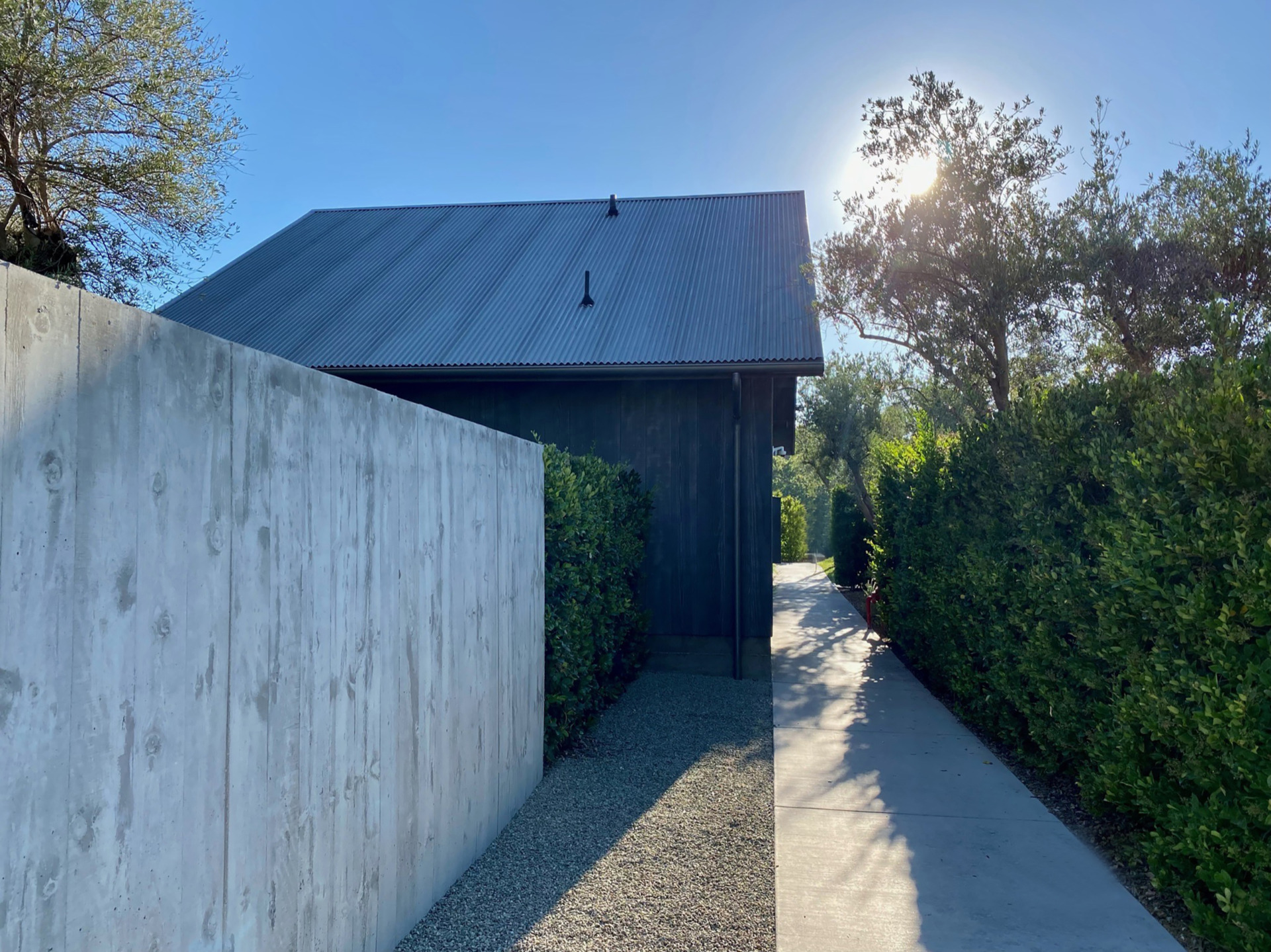 farmhouse at ojai with sun setting and bushes