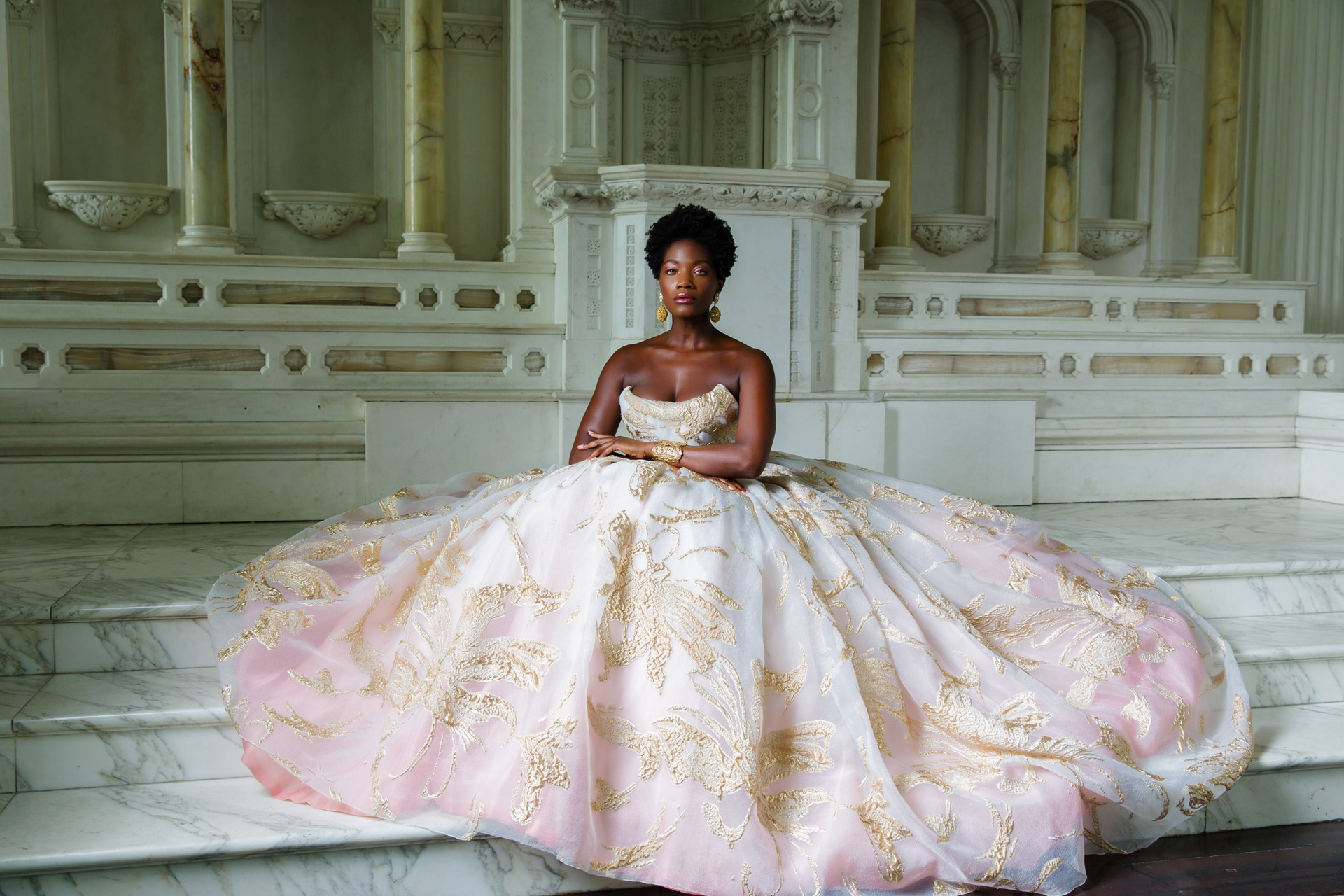 Bride in pink and white dress sitting on Vibiana alter