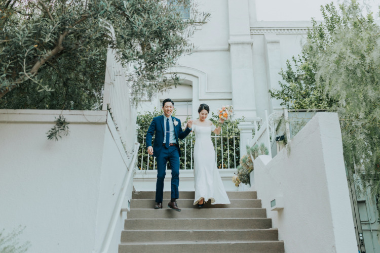 bride and groom coming downstairs