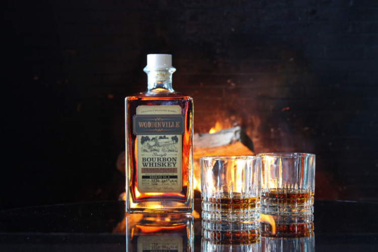 woodinville bourbon on a table with fireplace in background