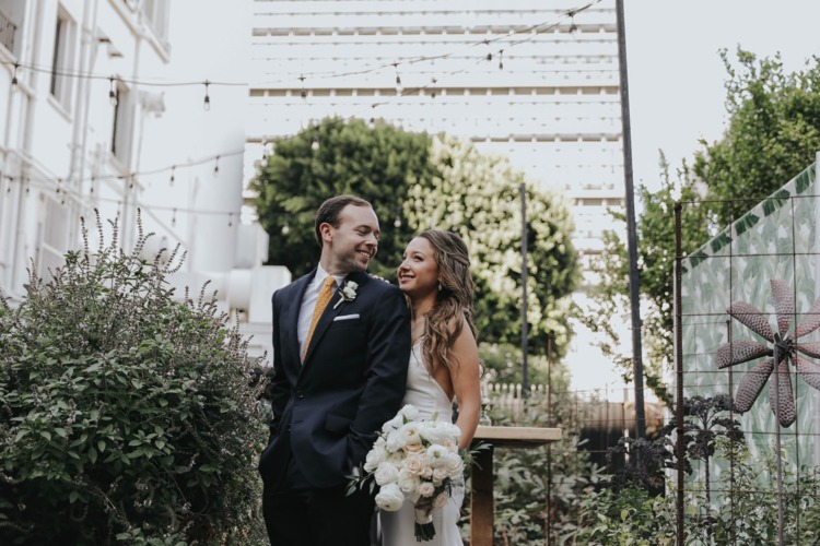 bride and groom in a garden