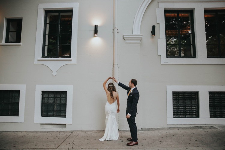 bride and groom dancing outside