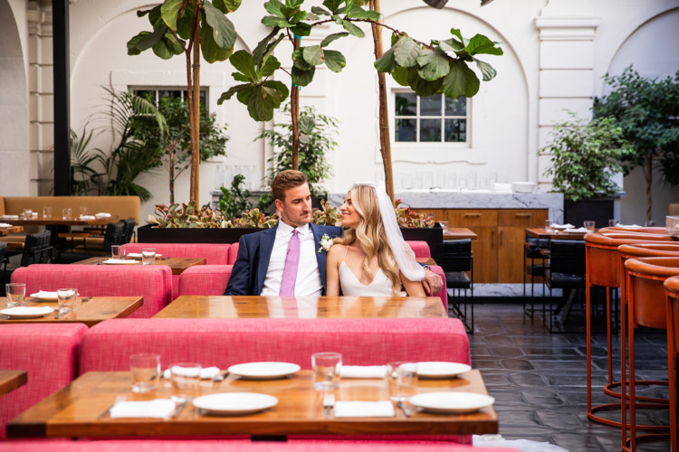 bride and groom sitting in redbird