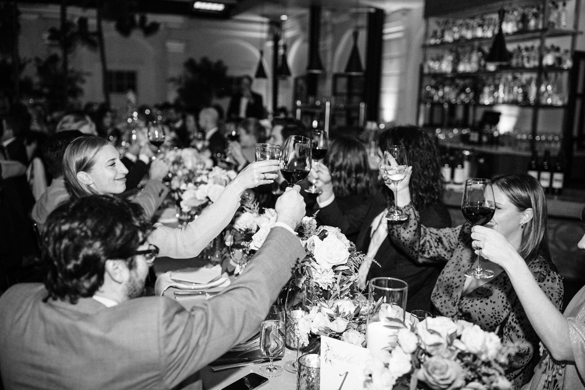 toasting at wedding in black and white