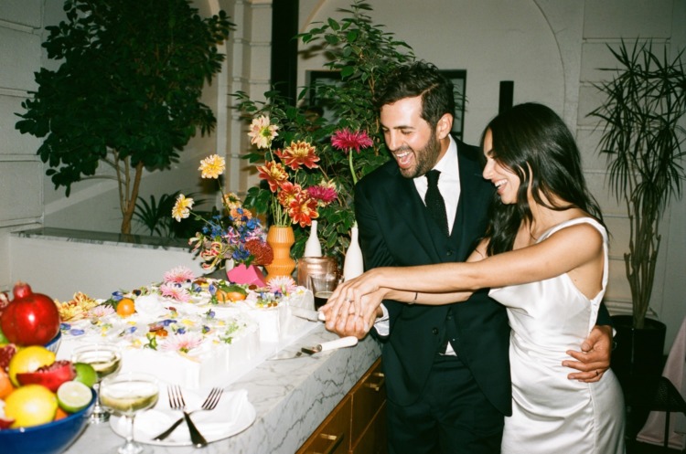 bride and groom cutting cake