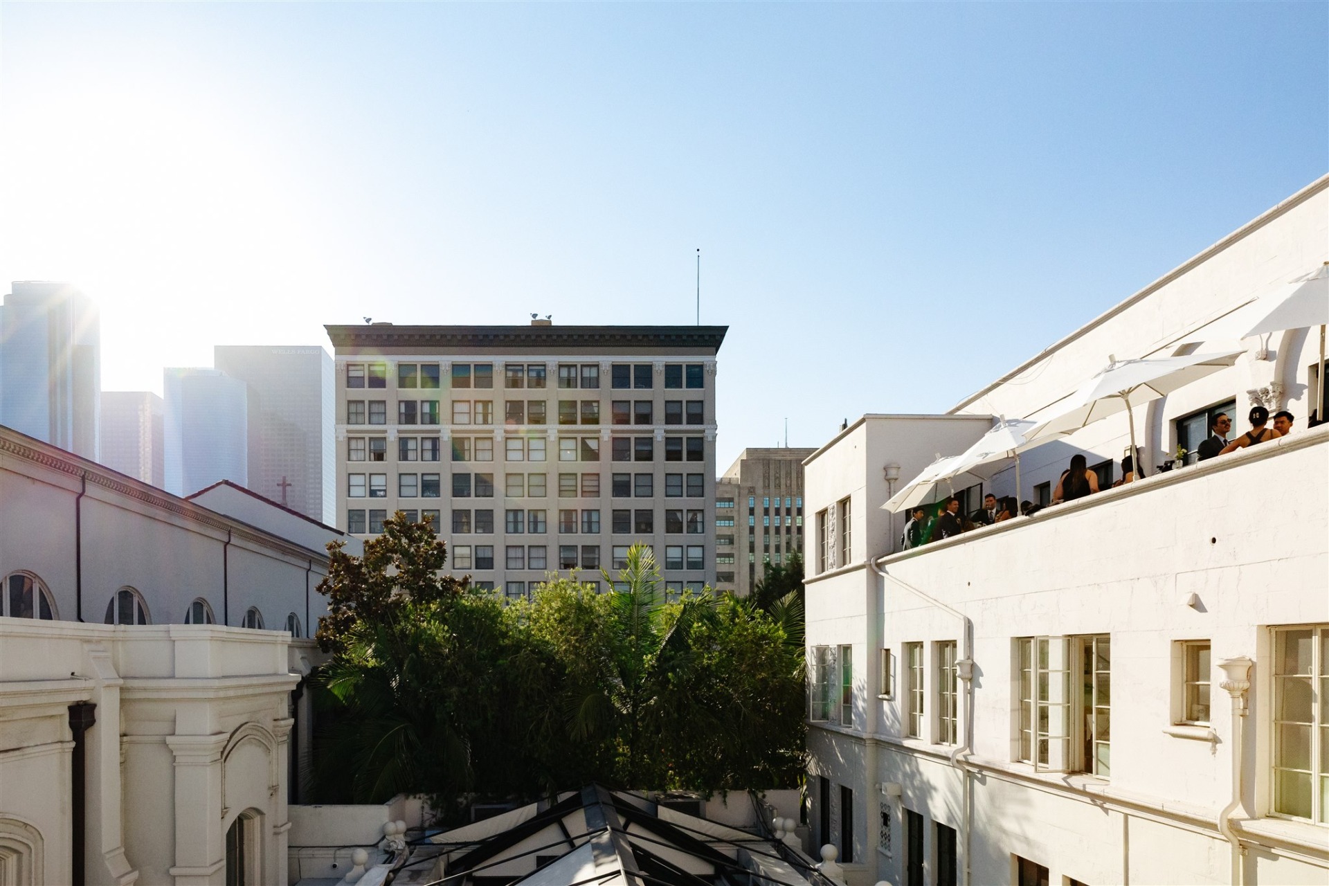 guests stand on a balcony overlooking downtown Los Angeles at the Redbird private event space Cardinal's Quarters