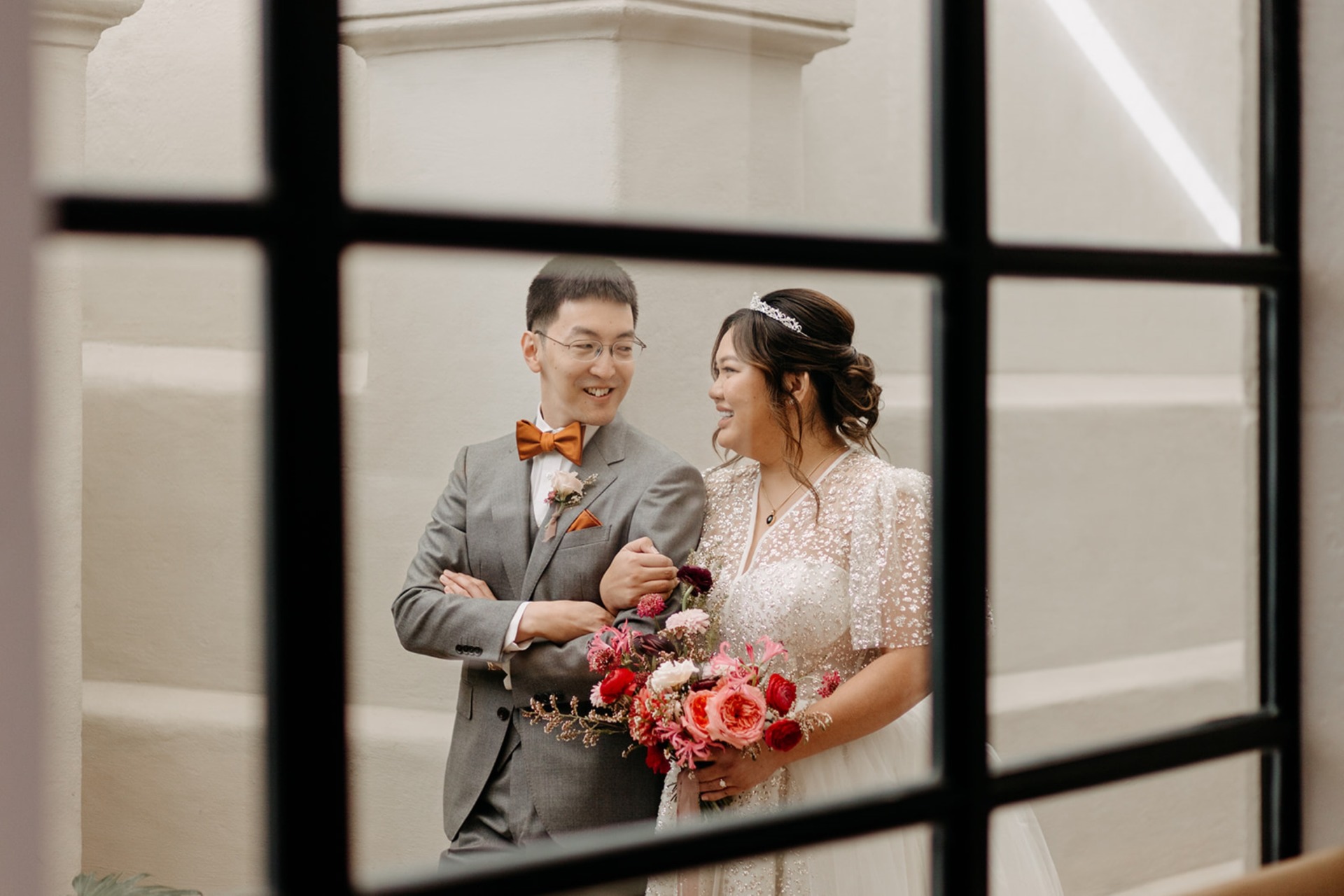 bride and groom through window