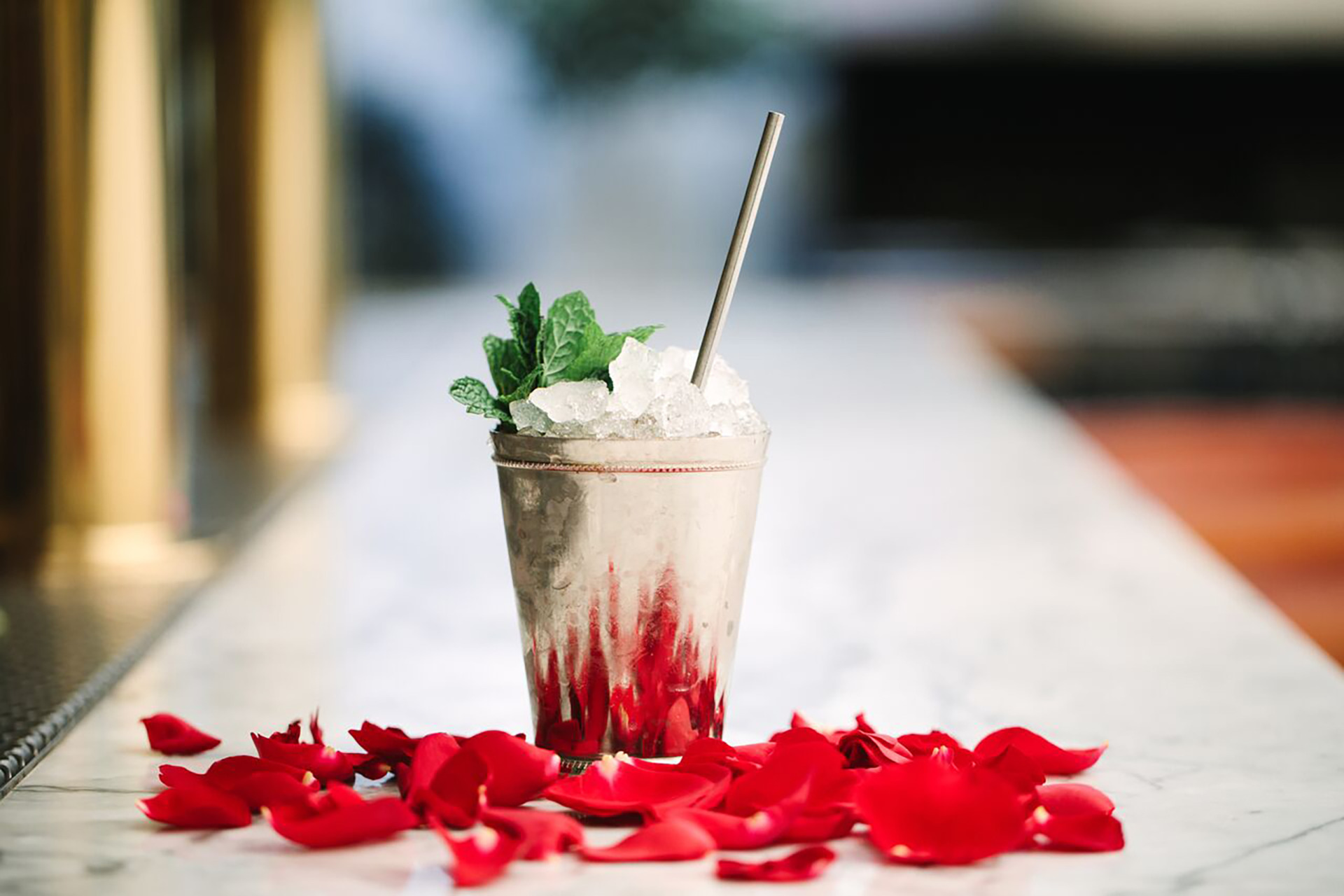 mint julep on bar with flowers