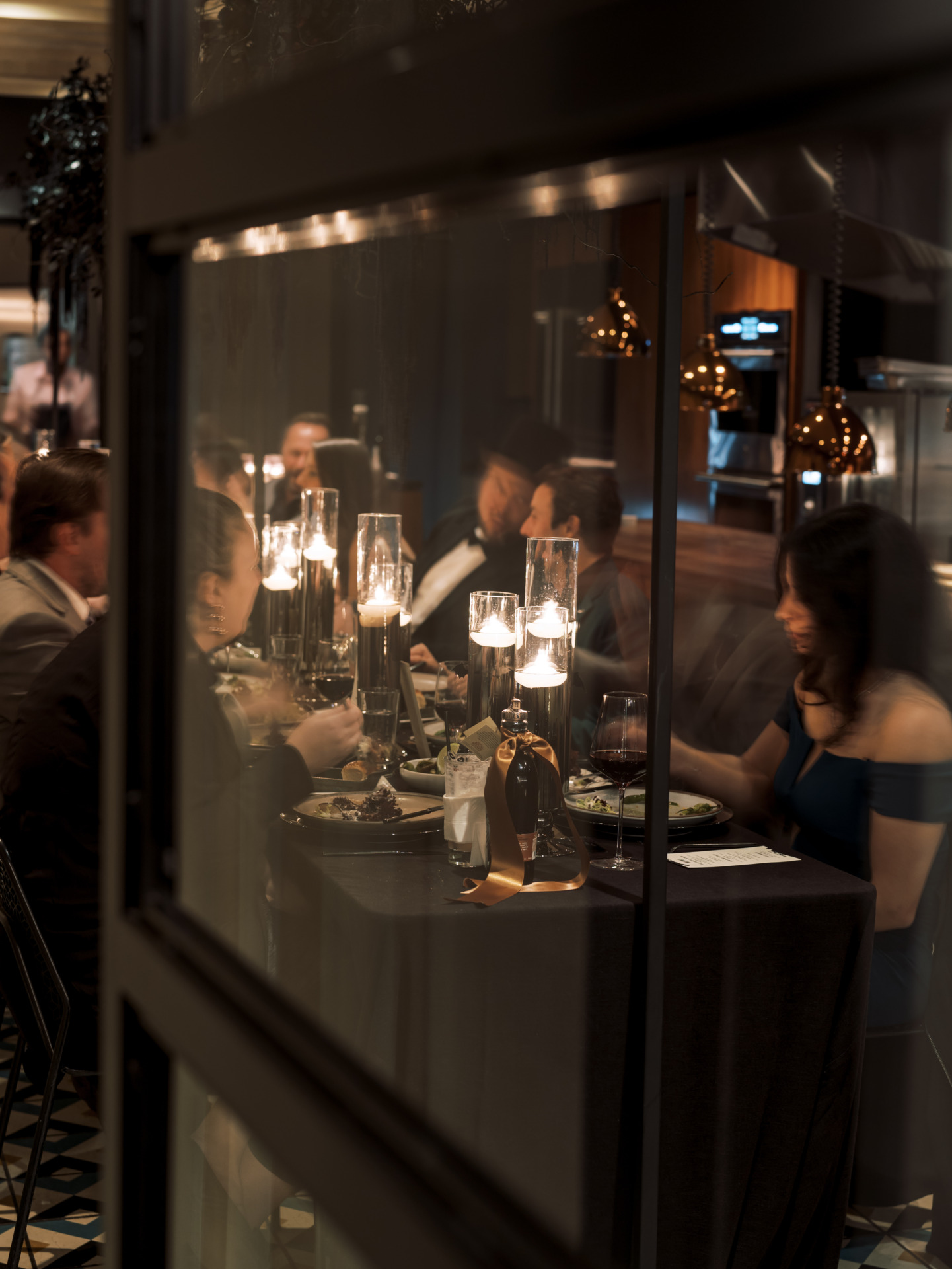 guests eating at a dinner party. dtla sazerac o.f.c. vintage bourbon dinner