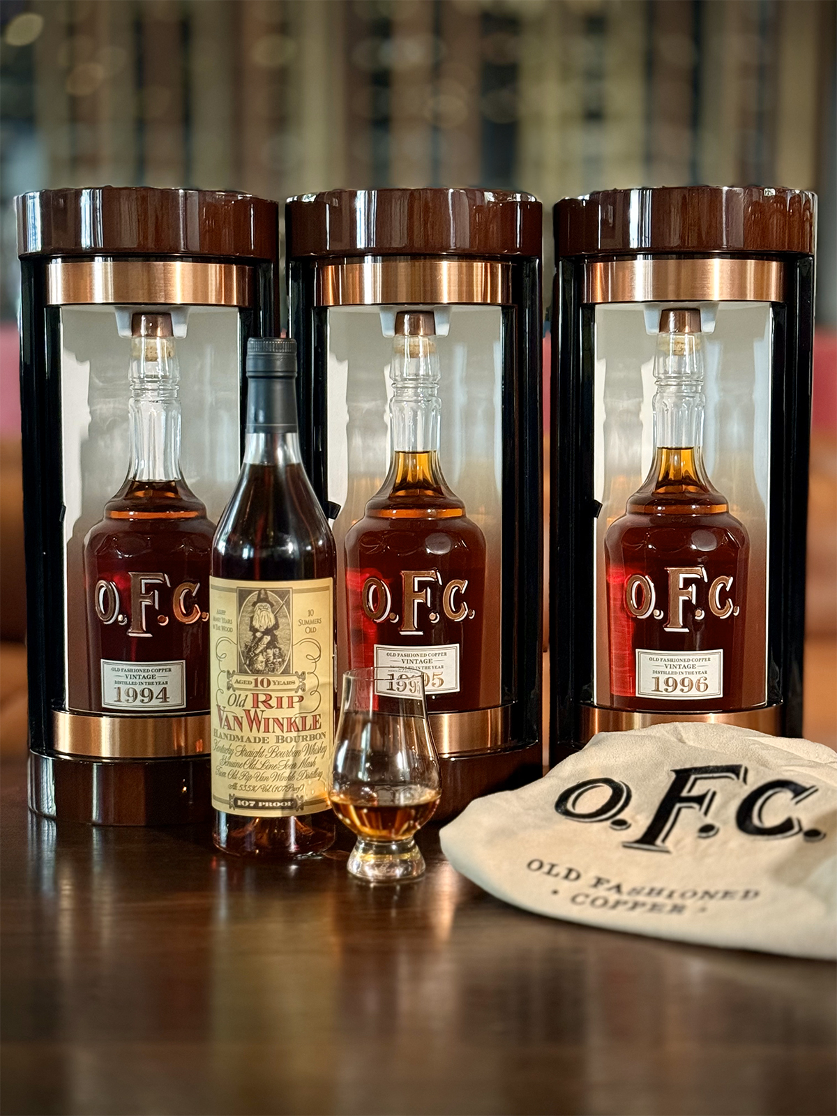 vintage bourbon bottles set out on a table with a glen cairn glass