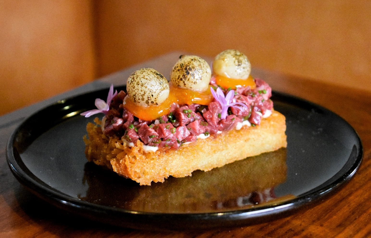 Beef Tartare with caramelized onion, egg jam, chive, on a potato rosti