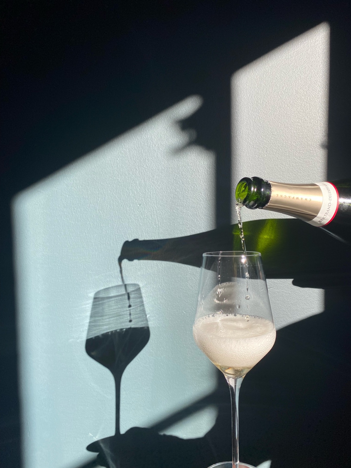 wine being poured into a white wine glass