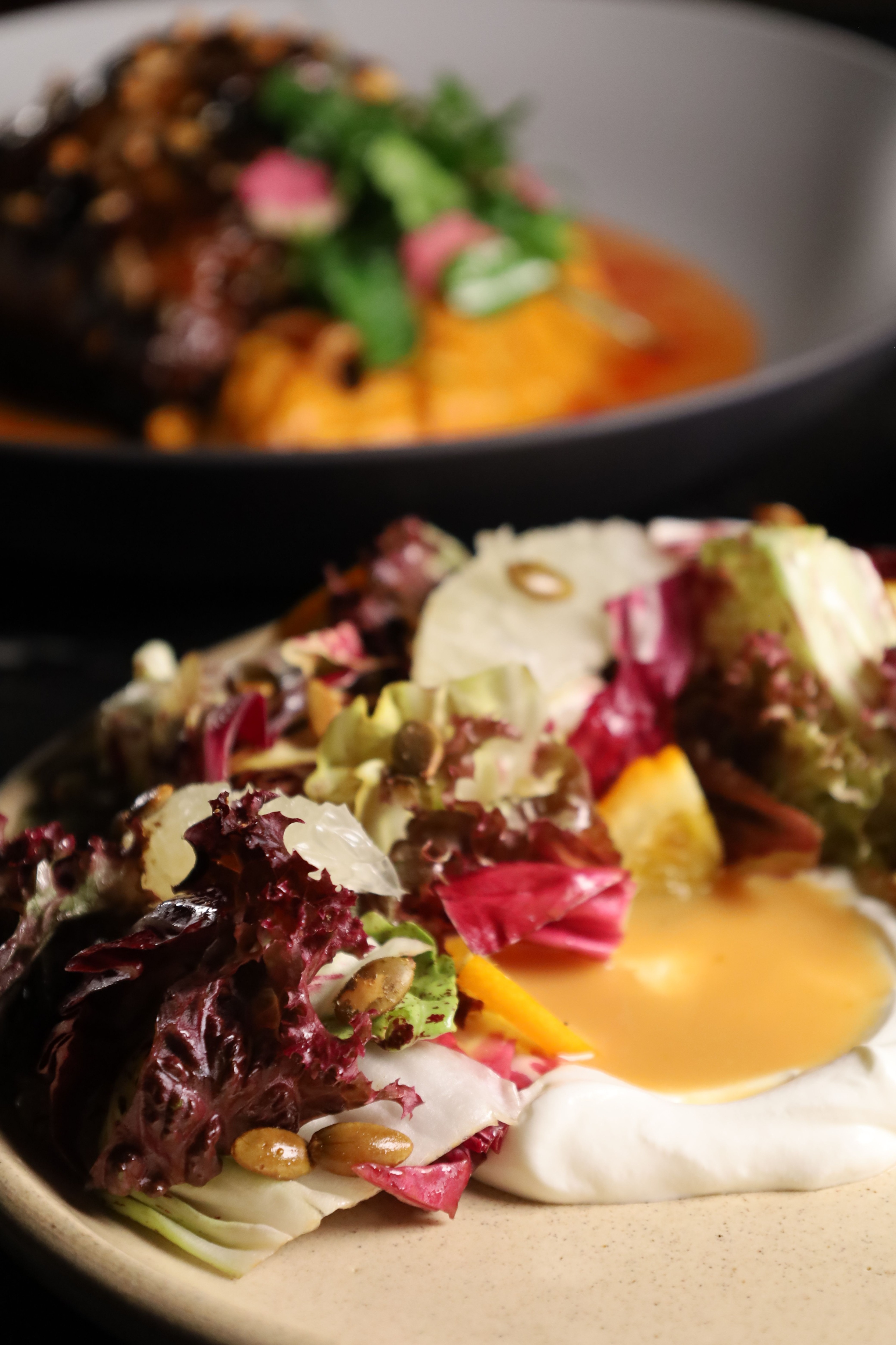 lettuce, pomelo segments, and whipped feta on a plate