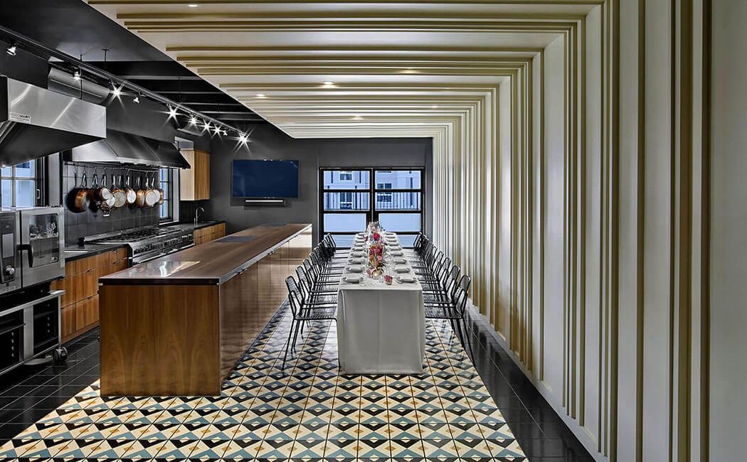 The dining room and kitchen looking out towards the open air balcony of the East Room at Redbird | Vibiana