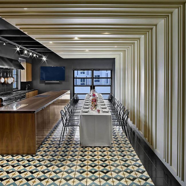 The dining room and kitchen looking out towards the open air balcony of the East Room at Redbird | Vibiana