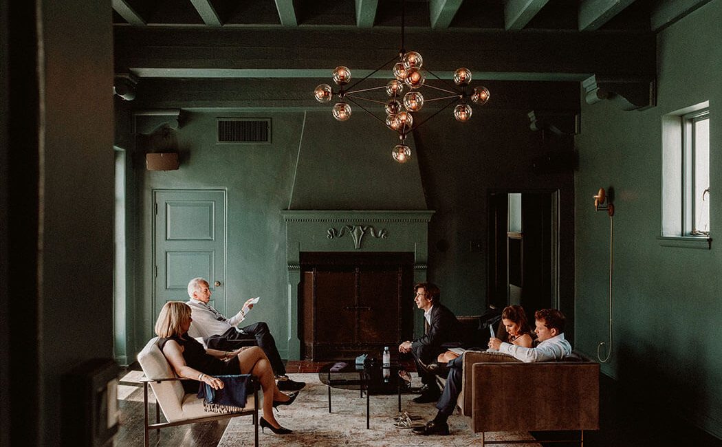 A family lounging in the Cardinal's Quarters at Redbird | Vibiana