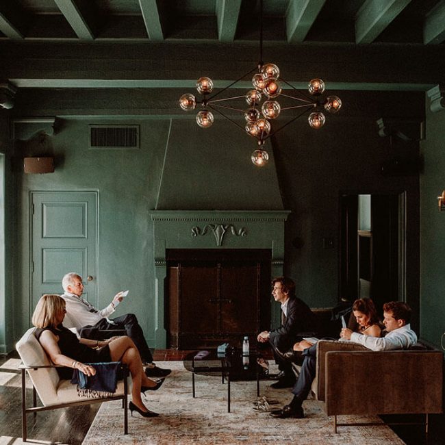 A family lounging in the Cardinal's Quarters at Redbird | Vibiana