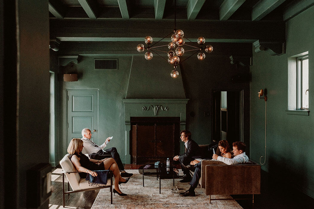 A family lounging in the Cardinal's Quarters at Redbird | Vibiana