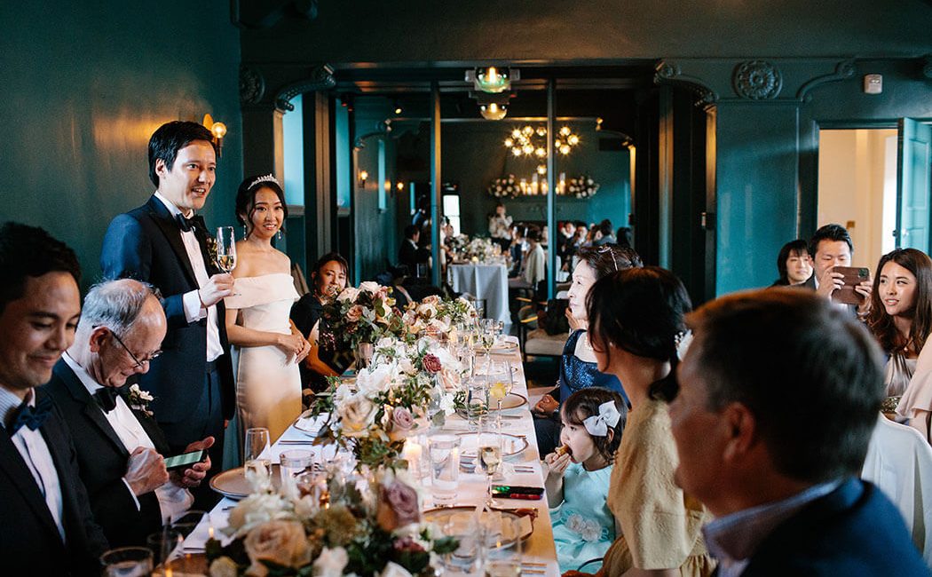 A wedding couple with guests in the Cardinal's Quarters at Redbird | Vibiana