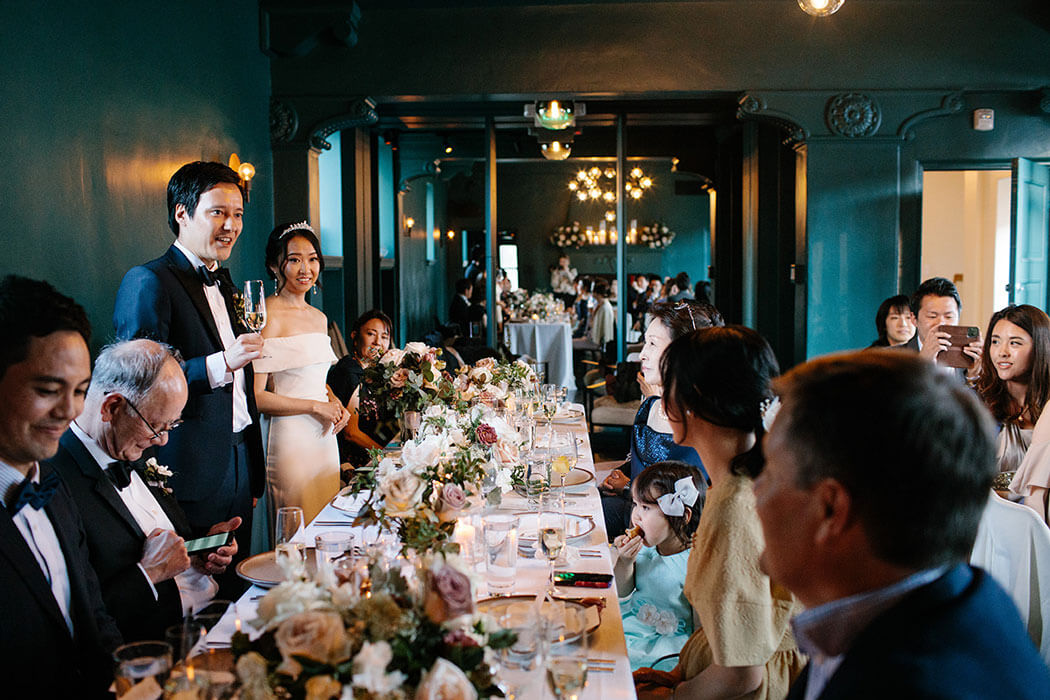 A wedding couple with guests in the Cardinal's Quarters at Redbird | Vibiana