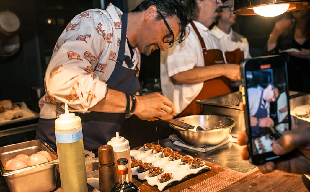 Guest Chef Chris Cosentino preparing dishes alongside Chef Neal Fraser in the East Room at Redbird | Vibiana
