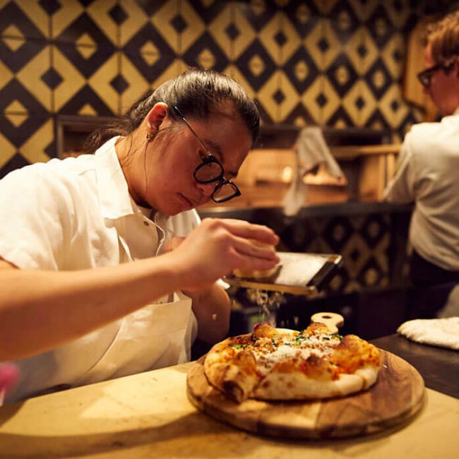 Chefs preparing pizzas in The Garden at Redbird | Vibiana