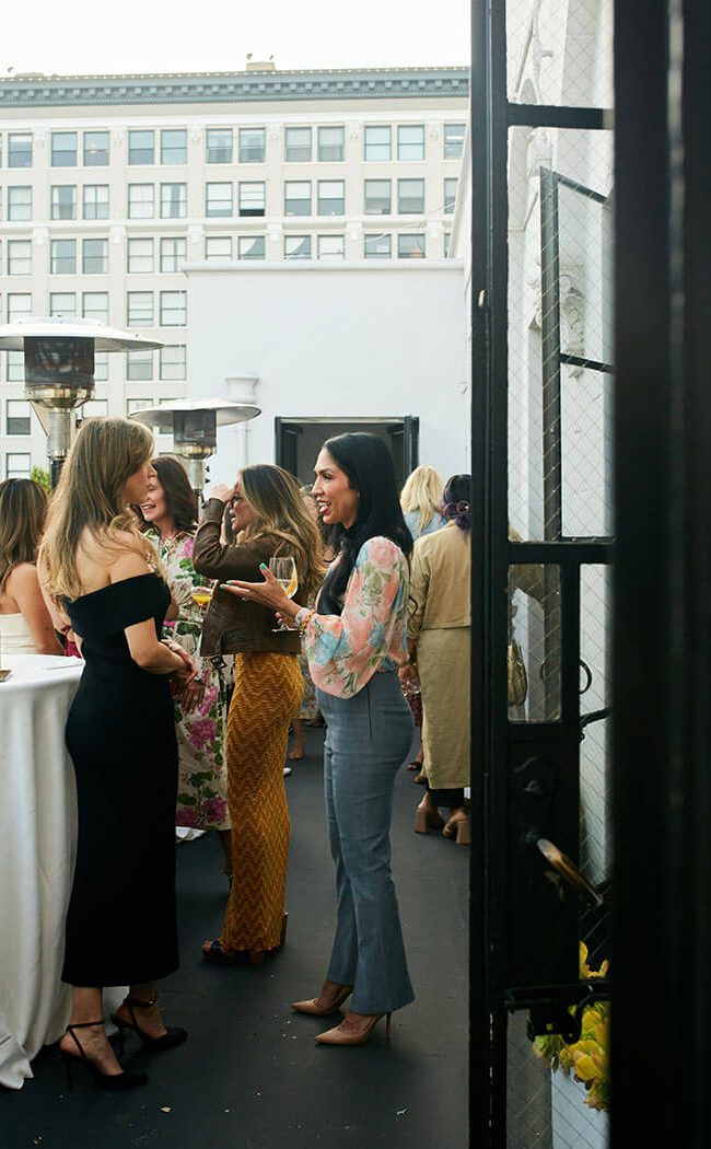Guests networking in the Cardinal's Quarters balcony at Redbird | Vibiana