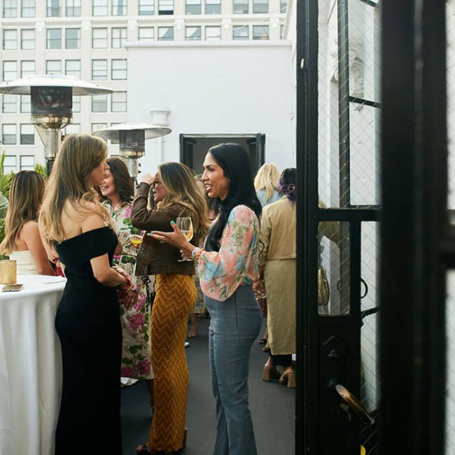 Guests networking in the Cardinal's Quarters balcony at Redbird | Vibiana