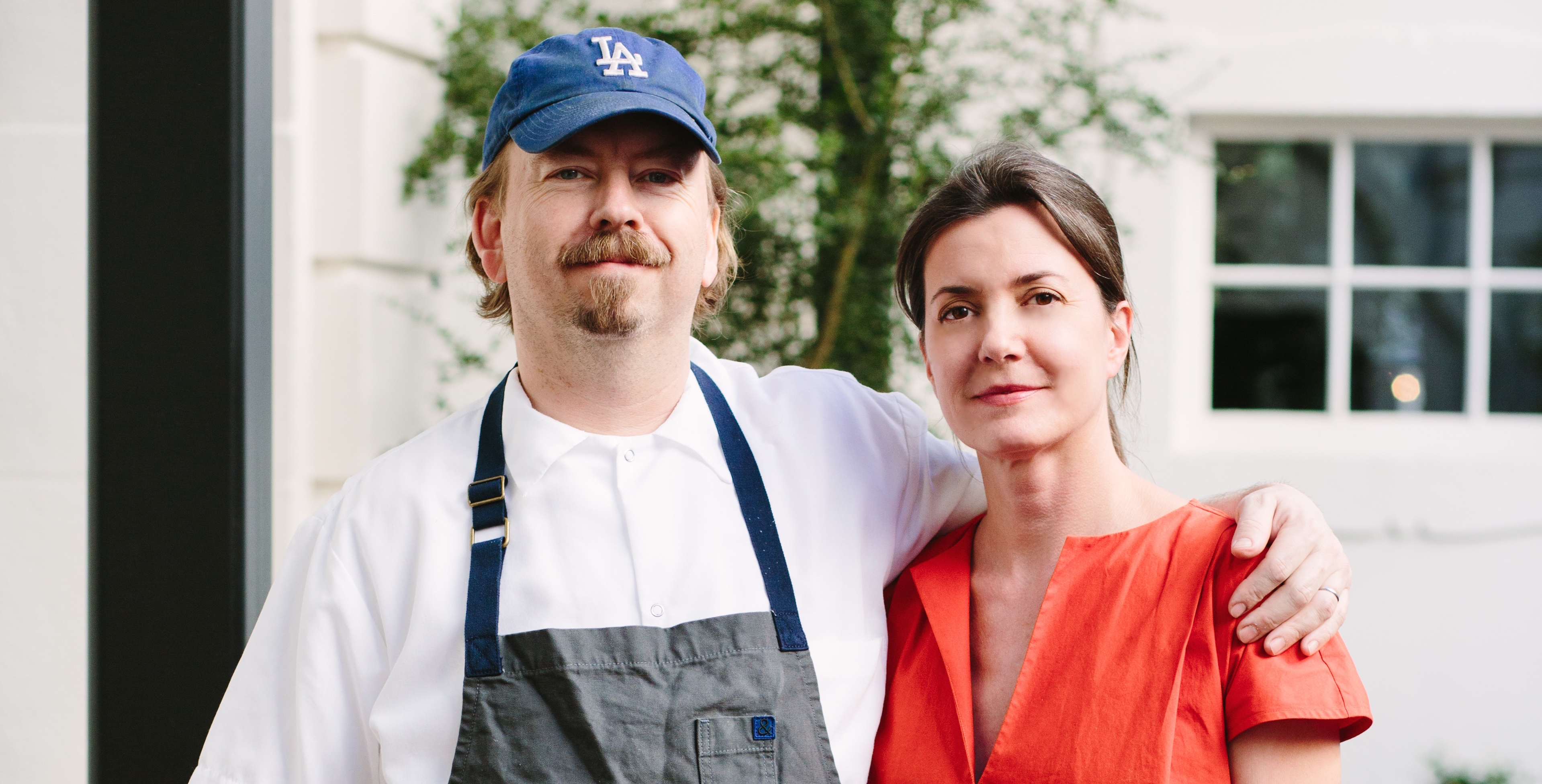 Chef Neal Fraser and Amy Knoll Fraser standing outside redbird