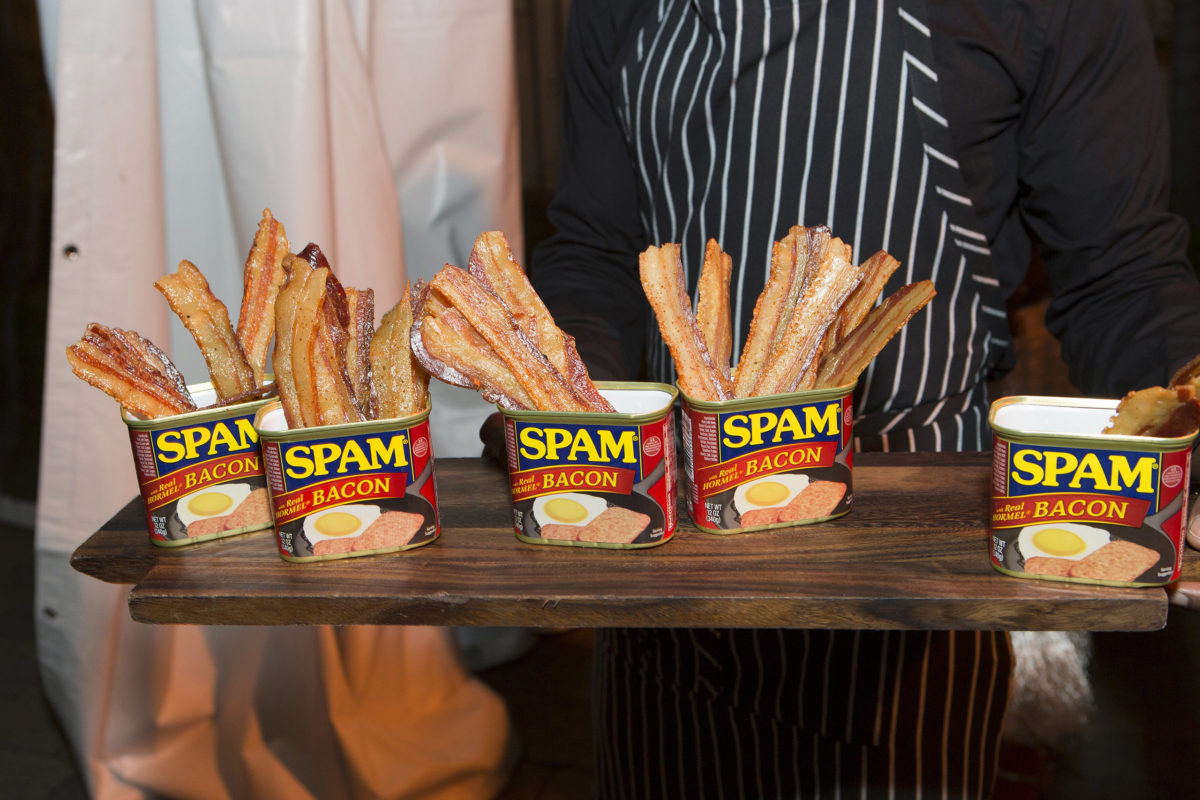 wood platter with 5 tins of spam filled with bacon