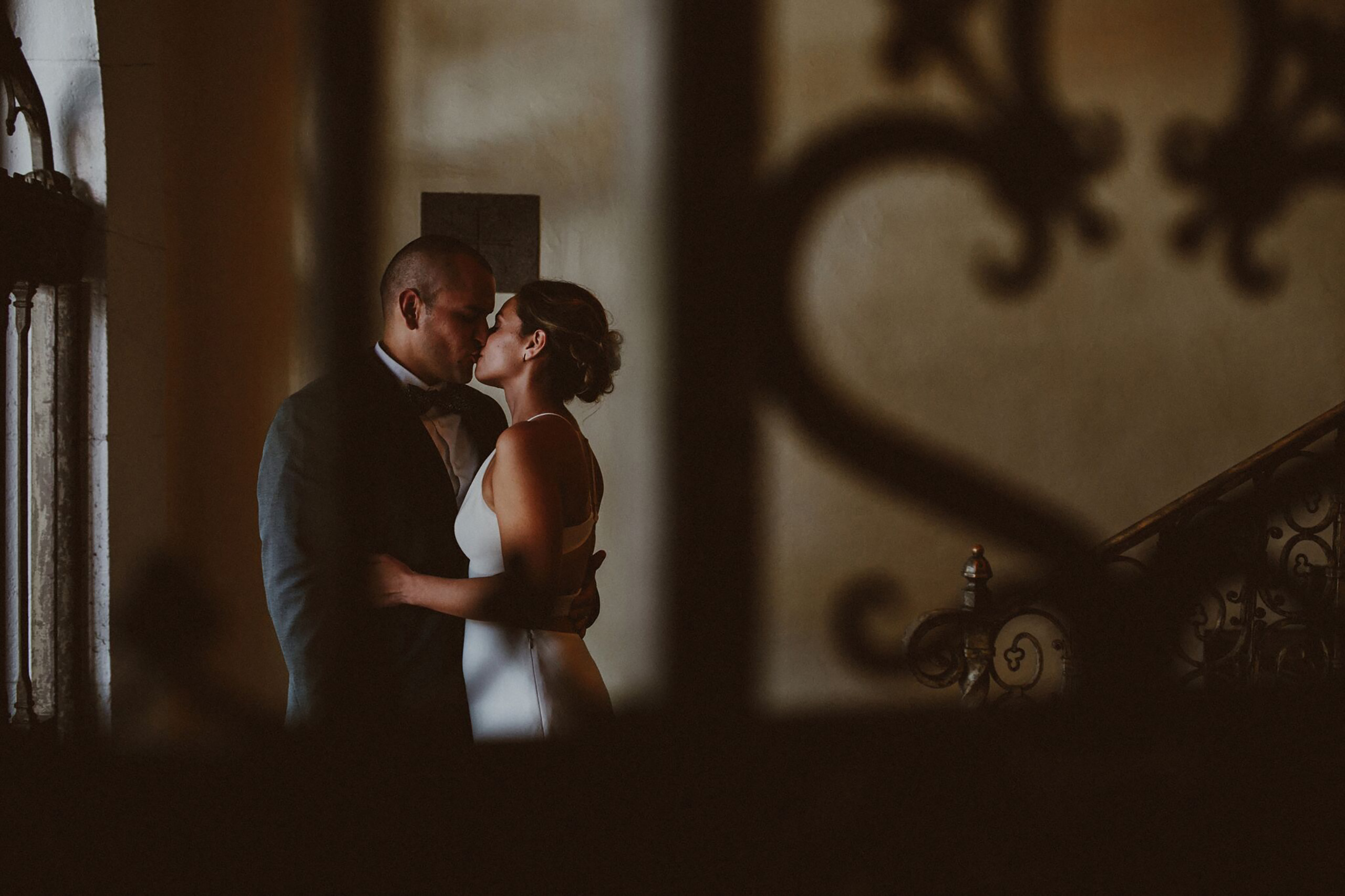 a bride and groom kissing in the entrance