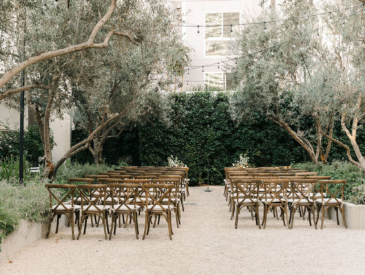 outdoor garden area setup with wood chairs for a wedding
