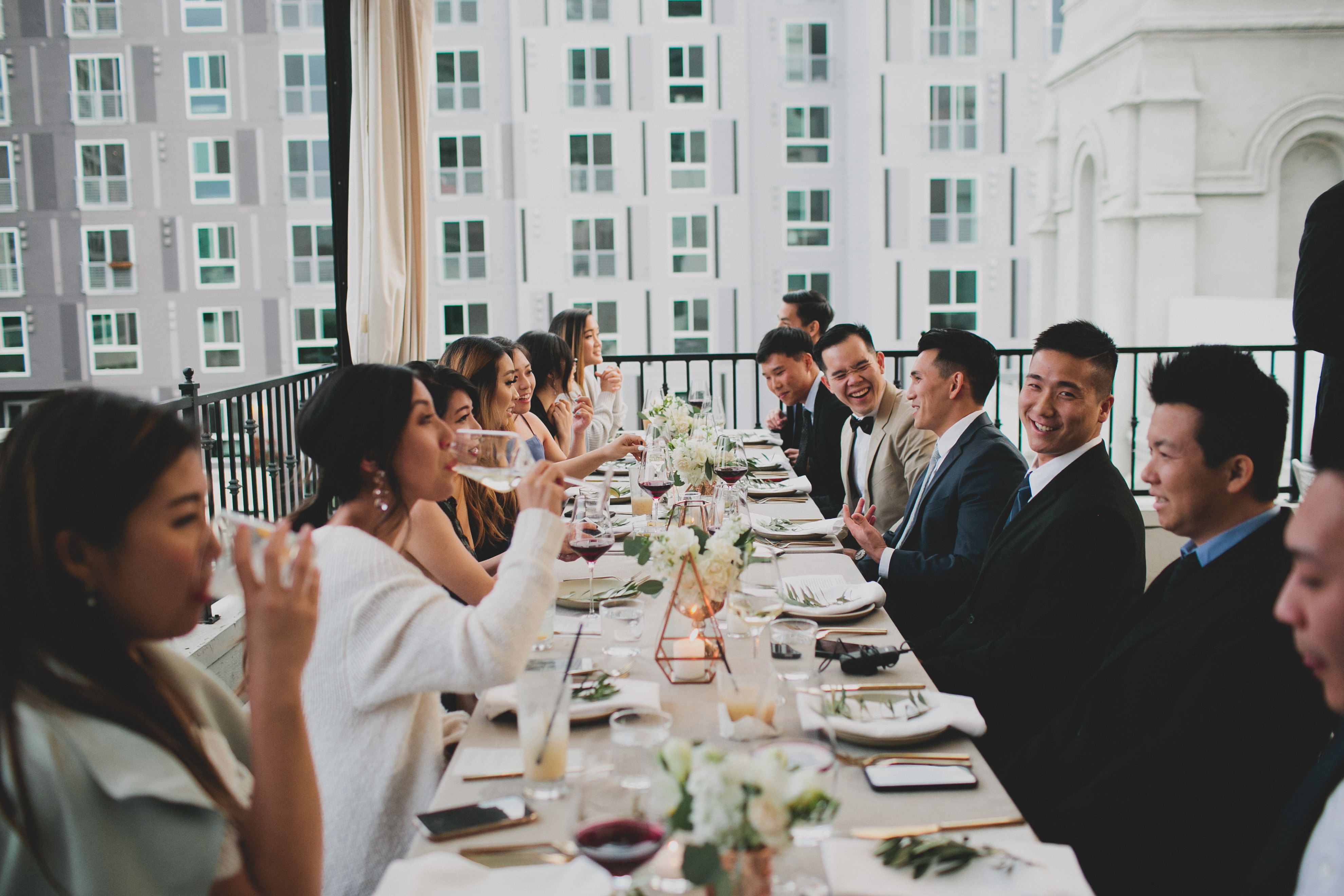 outdoor long table filled with guests mingling