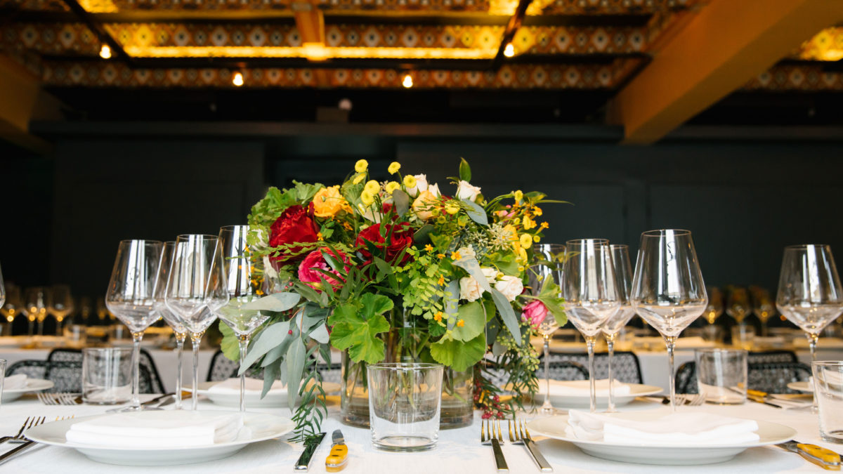 Table Setting with Red, Yellow and Green Flowers