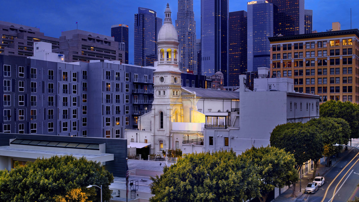 skyline of DTLA with historic Vibiana in front