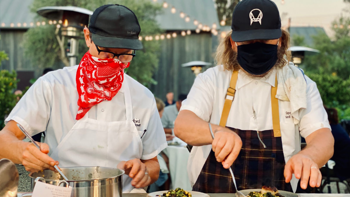 two chefs- Jason Bowlin and Neal Fraser of Redbird- cooking with hats, aprons and masks at the ojai valley inn