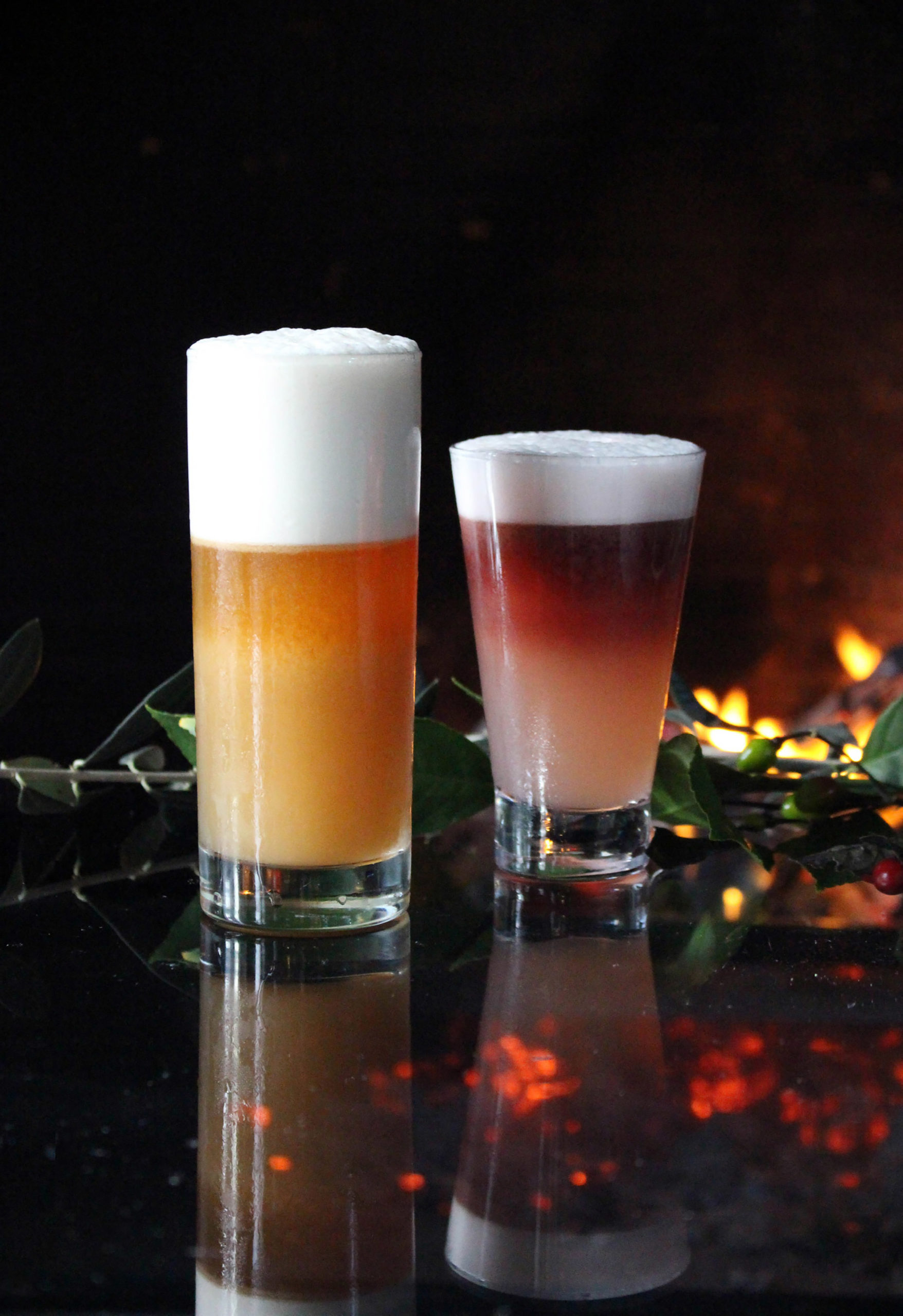 Two cocktails in front of a fire