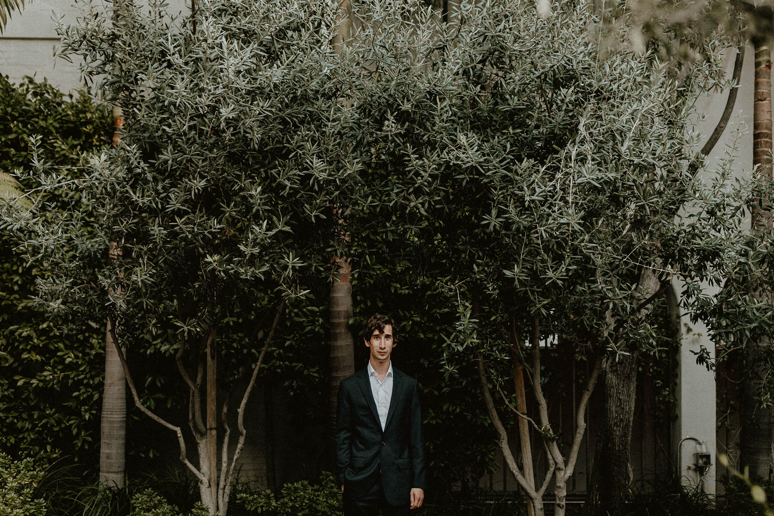 groom in front of trees
