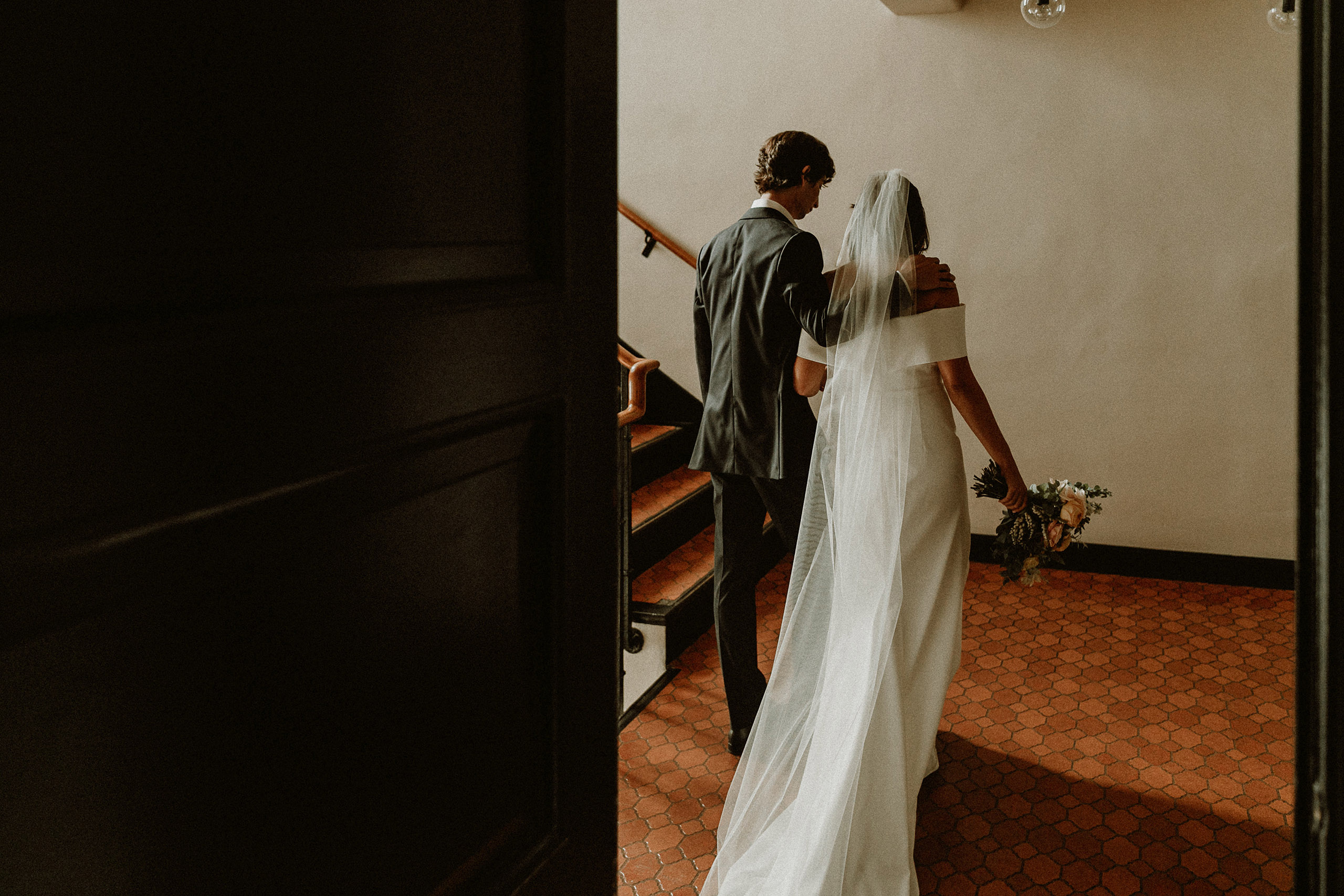 bride and groom walking upstairs